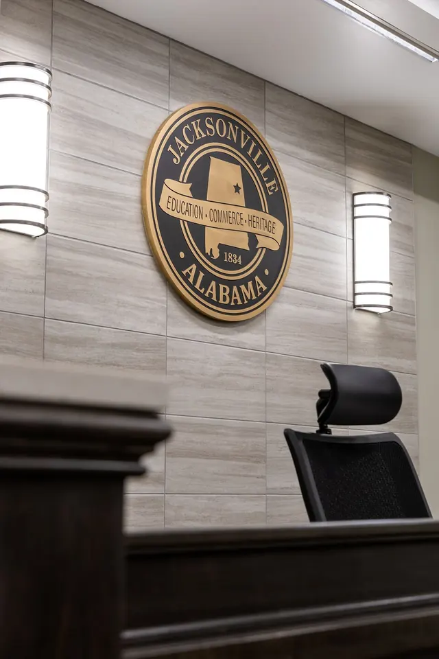 Jacksonville City seal on a stone wall above the council dais