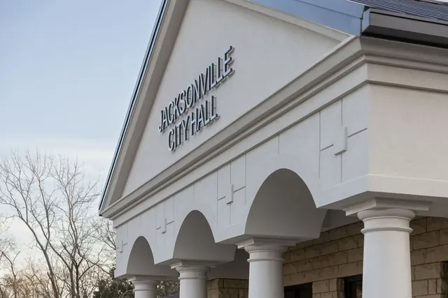Jacksonville City Hall sign on the white gable over the arched entrance