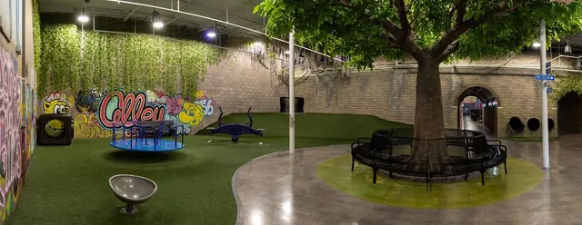 Indoor park at The Alley with turf, a tree and seating