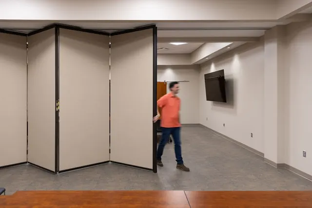 Folding partition opening between two meeting rooms