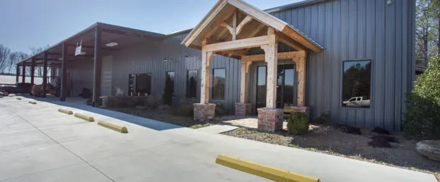 Batey & Sanders, a gray metal building with a timber-framed entry