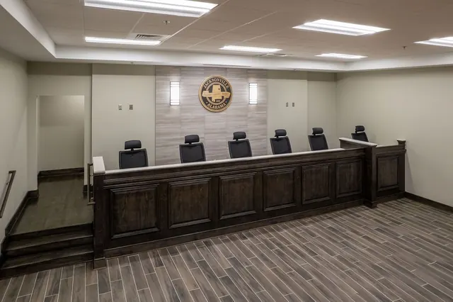 Council chambers inside Jacksonville City Hall, with the raised dark wood dais and the city seal on the wall
