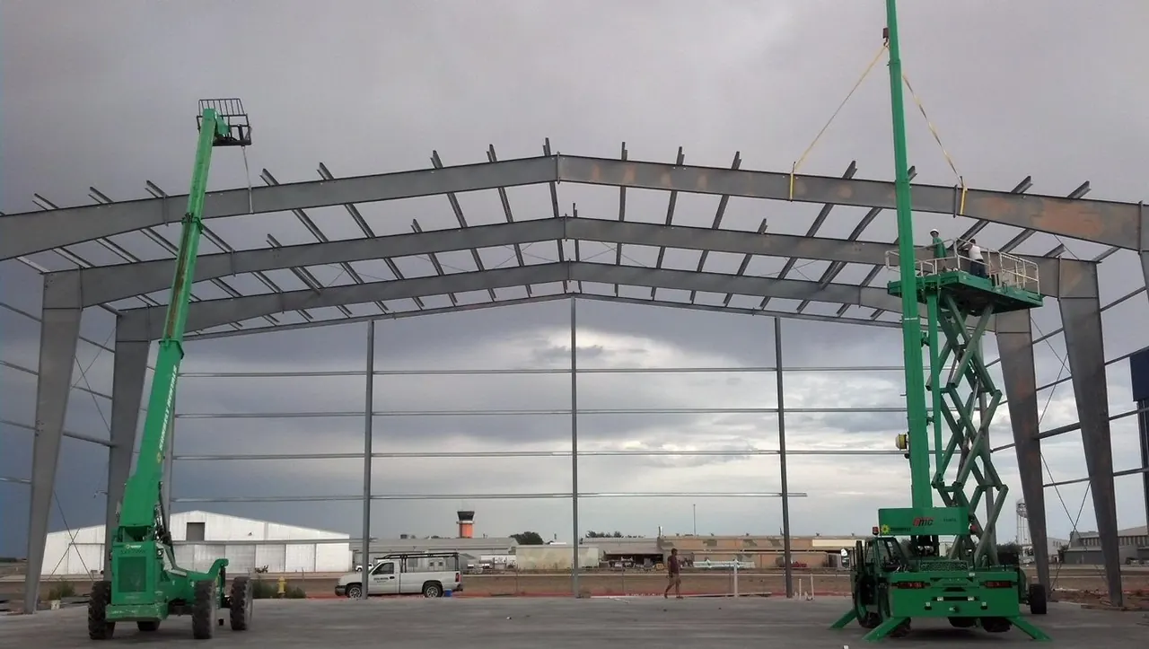 Hangar steel going up with a lift on a Greer job